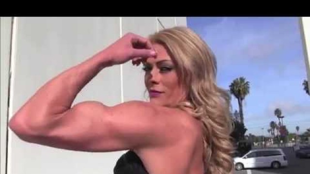 'Tall Fitness Woman flexing her muscles and posing'