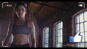 'Beautiful Kickboxing woman training punching bag in fitness studio fierce strength fit body kickboxe'