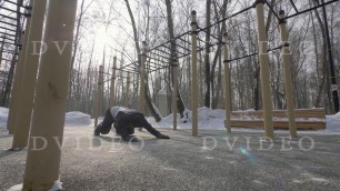 'Fitness man doing push ups and stretching exercises on winter sports training'