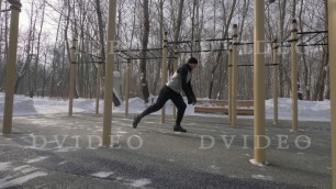 'Fitness man doing squat exercise on winter sports ground outdoor'